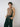 a male model posing wearing yvy black net tanktop, wide black eyelet belt, and eyelet black bracelet