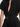 a close-up of black yvy plisse dress with a slit in the front, with black yvy buckle belt on the waist