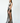 a female model wearing a handmade black yvy leather dress made with leather straps