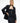 A female model wearing the black tube dress with tailored black yvy suit jacket, paired with the statement leather belt with metallic buckle 