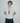 man wearing yvy long leather ring key holder with key covers over white polo t-shirt