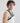 side profile of male model wearing yvy leather uni shoulderpiece in black over a white tank top