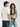 male and female models standing together; he is wearing a classic white t-shirt with "pleasant sensations" logo on the back and buckled leather yvy trousers, she is wearing a black leather bra, blue jeans and eyelet yvy belt