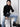 woman wearing black turtleneck and jeans with yvy leather moon bag over neck with shoulderstrap