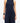 a woman wearing yvy navy blue elegant jumpsuit and black leather yvy eileen bracelet with silver detail