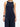a woman wearing yvy navy blue elegant jumpsuit and black leather yvy eileen bracelet with silver detail