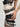 white and black yvy eyelet belts wrapped around the female body