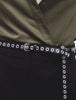 a video of a female model posing in thin black yvy eyelet belt with silver hardware over black pants, yvy leather eyelet choker and green linen long sleeve shirt
