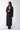 female model wearing yvy classic black jacket and black maxi leather skirt
