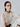 woman wearing yvy dark brown leather ring choker with gold hardware and white mesh top